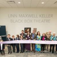 Family and friends cut the dedication ribbon.